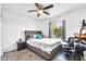 Cozy bedroom featuring a ceiling fan, comfortable bed, and natural light from the window at 3129 W Pierce St, Phoenix, AZ 85009