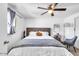 Bedroom featuring a stylish bed, mirror, and chair, offering a relaxing space at 3129 W Pierce St, Phoenix, AZ 85009