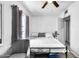 Simple bedroom with a metal bed frame, neutral bedding, and a window with gray curtains at 3129 W Pierce St, Phoenix, AZ 85009