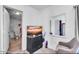 Cozy bedroom featuring a chair, dresser with a TV, and a view into the bathroom at 3129 W Pierce St, Phoenix, AZ 85009