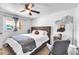 Bedroom featuring a stylish bed, mirror, chair and natural light from the window at 3129 W Pierce St, Phoenix, AZ 85009