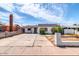 Exterior shot showing a well-maintained home with a long driveway, quaint front yard, and decorative chimney at 3129 W Pierce St, Phoenix, AZ 85009