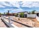 Charming single-story home with white stucco walls, fence and desert landscaping under a partly cloudy sky at 3129 W Pierce St, Phoenix, AZ 85009