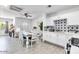 Bright open-concept kitchen/dining area with star backsplash, white cabinets, and modern furnishings at 3129 W Pierce St, Phoenix, AZ 85009