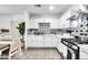 Bright kitchen featuring white cabinetry, stainless steel appliances, and stylish star patterned backsplash at 3129 W Pierce St, Phoenix, AZ 85009