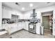 Well-lit kitchen features white cabinetry, star-patterned backsplash, stainless steel appliances, and modern finishes at 3129 W Pierce St, Phoenix, AZ 85009