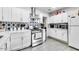 Updated kitchen showcasing white cabinets, stainless steel appliances, and star-patterned backsplash at 3129 W Pierce St, Phoenix, AZ 85009