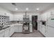 Clean kitchen features stainless steel appliances, tile flooring, and white cabinets at 3129 W Pierce St, Phoenix, AZ 85009