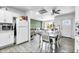 Open-concept living and kitchen area with dining table, white cabinets, and neutral decor at 3129 W Pierce St, Phoenix, AZ 85009