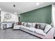 Comfortable living room featuring a plush sectional sofa, stylish decor, and wood-look tile flooring at 3129 W Pierce St, Phoenix, AZ 85009