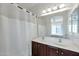 Cozy bathroom featuring a double vanity sink, large mirror, and shower with curtain at 3428 E Lance Ln, Phoenix, AZ 85018