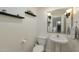 Cozy half bathroom featuring decorative shelves, framed mirror and pedestal sink at 3428 E Lance Ln, Phoenix, AZ 85018