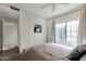 Well-lit bedroom with ensuite bath access, built-in closet storage, and large window at 3428 E Lance Ln, Phoenix, AZ 85018