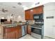 This kitchen features granite countertops, stainless steel appliances, and wooden cabinets at 3428 E Lance Ln, Phoenix, AZ 85018