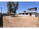 Expansive backyard with mature trees, a storage shed, and a white exterior home with a red door at 3547 W Encanto Blvd, Phoenix, AZ 85009