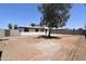 View of backyard featuring tree in center and a two story home at 3547 W Encanto Blvd, Phoenix, AZ 85009