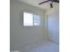 Bright bedroom with white walls and marble-like tile flooring and a modern ceiling fan at 3547 W Encanto Blvd, Phoenix, AZ 85009