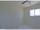 Bright bedroom with white-tiled floor, window, and ceiling fan at 3547 W Encanto Blvd, Phoenix, AZ 85009