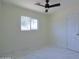 Light-filled bedroom with sleek tile floors, a window, and a ceiling fan at 3547 W Encanto Blvd, Phoenix, AZ 85009