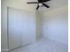 Bedroom with white closet doors and a modern ceiling fan at 3547 W Encanto Blvd, Phoenix, AZ 85009