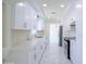 Well-lit kitchen with white cabinetry, stainless steel appliances, and stylish tile flooring at 3547 W Encanto Blvd, Phoenix, AZ 85009