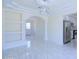 Open-concept living space featuring marble-look tile flooring, modern lighting, and seamless flow to kitchen at 3547 W Encanto Blvd, Phoenix, AZ 85009