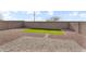 Backyard patio featuring low-maintenance landscaping with gravel, artificial grass, and a brick wall at 36852 N Yellowstone Dr, San Tan Valley, AZ 85140