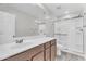 Well-lit bathroom featuring a modern vanity, large mirror, and a glass-enclosed shower at 36852 N Yellowstone Dr, San Tan Valley, AZ 85140