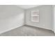 Clean bedroom with neutral carpet, white walls, and a window providing natural light at 36852 N Yellowstone Dr, San Tan Valley, AZ 85140