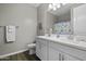 A bright bathroom featuring double sinks, a neutral color scheme, and decorative starfish accents at 38162 W Santa Monica Ave, Maricopa, AZ 85138