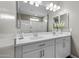 Bathroom vanity with double sinks, white cabinets, and a large mirror, providing ample space at 38162 W Santa Monica Ave, Maricopa, AZ 85138