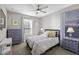 A well-lit bedroom featuring a dresser, nightstands, and a decorative lamp at 38162 W Santa Monica Ave, Maricopa, AZ 85138