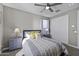 A well-lit bedroom featuring a dresser, nightstands, and a decorative lamp at 38162 W Santa Monica Ave, Maricopa, AZ 85138