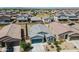 An aerial view shows a well-maintained home with desert landscaping and a blue garage door at 40176 W Williams Way, Maricopa, AZ 85138