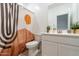 Modern bathroom with a stylish shower curtain, white vanity, and contemporary fixtures at 40176 W Williams Way, Maricopa, AZ 85138