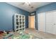 Spacious bedroom with blue walls, a large closet, and a view into the hall, providing an open feel at 40176 W Williams Way, Maricopa, AZ 85138