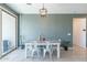 Bright dining room with a modern table, chairs, stylish light fixture, and large sliding glass door at 40176 W Williams Way, Maricopa, AZ 85138