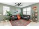 Cozy living room with modern decor, comfortable sofas, a ceiling fan, and large windows at 40176 W Williams Way, Maricopa, AZ 85138