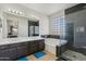 Bathroom with dual sinks, soaking tub, and separate glass-enclosed shower at 4043 W Aire Libre Ave, Phoenix, AZ 85053