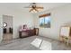 Bright bedroom with wood-look floors and a large window for natural light at 4043 W Aire Libre Ave, Phoenix, AZ 85053