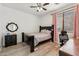 Bedroom featuring wood-look floors, ceiling fan, and desk area at 4043 W Aire Libre Ave, Phoenix, AZ 85053