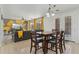 Open-concept dining area next to the living room with views to backyard, wood-look flooring and stylish furniture at 4043 W Aire Libre Ave, Phoenix, AZ 85053