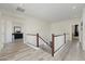 Upstairs hallway showcasing wood-look floors and staircase with white railings at 4043 W Aire Libre Ave, Phoenix, AZ 85053