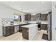 Modern kitchen with stainless steel appliances, a large center island, and views to the backyard at 4043 W Aire Libre Ave, Phoenix, AZ 85053