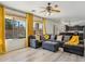 Comfortable living room boasts large windows, recessed lighting, and stylish gray sectional sofa with yellow accents at 4043 W Aire Libre Ave, Phoenix, AZ 85053