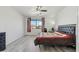 Spacious main bedroom features neutral walls, a ceiling fan, and large window at 4043 W Aire Libre Ave, Phoenix, AZ 85053