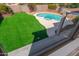 Lush backyard featuring green turf, a private pool, and cozy spa for relaxation at 4216 E Tether Trl, Phoenix, AZ 85050