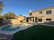 Exterior view of the backyard featuring a pool, patio, and green grass at 4216 E Tether Trl, Phoenix, AZ 85050