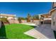 Inviting backyard with a covered patio, artificial turf, and refreshing private pool at 4216 E Tether Trl, Phoenix, AZ 85050