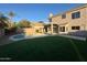 Lush backyard with artificial grass and a pool, perfect for relaxation and outdoor entertainment at 4216 E Tether Trl, Phoenix, AZ 85050